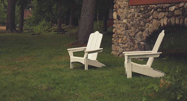Outdoor chairs on lawn in backyard