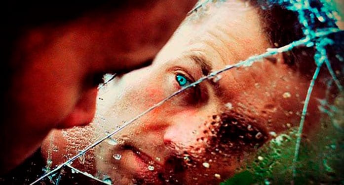 Man looking through cracked glass
