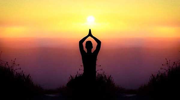 Practicing yoga as the sun falls