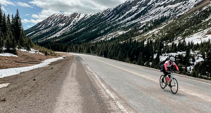 Lisa Monforton, ConnecTour group member, rides the road the Highwood Pass, at 2,206 metres, the highest elevation paved pass in Canada