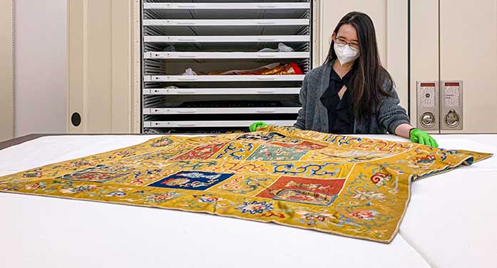 Arts student Sung Eun Cho with Buddhist monk silk robe